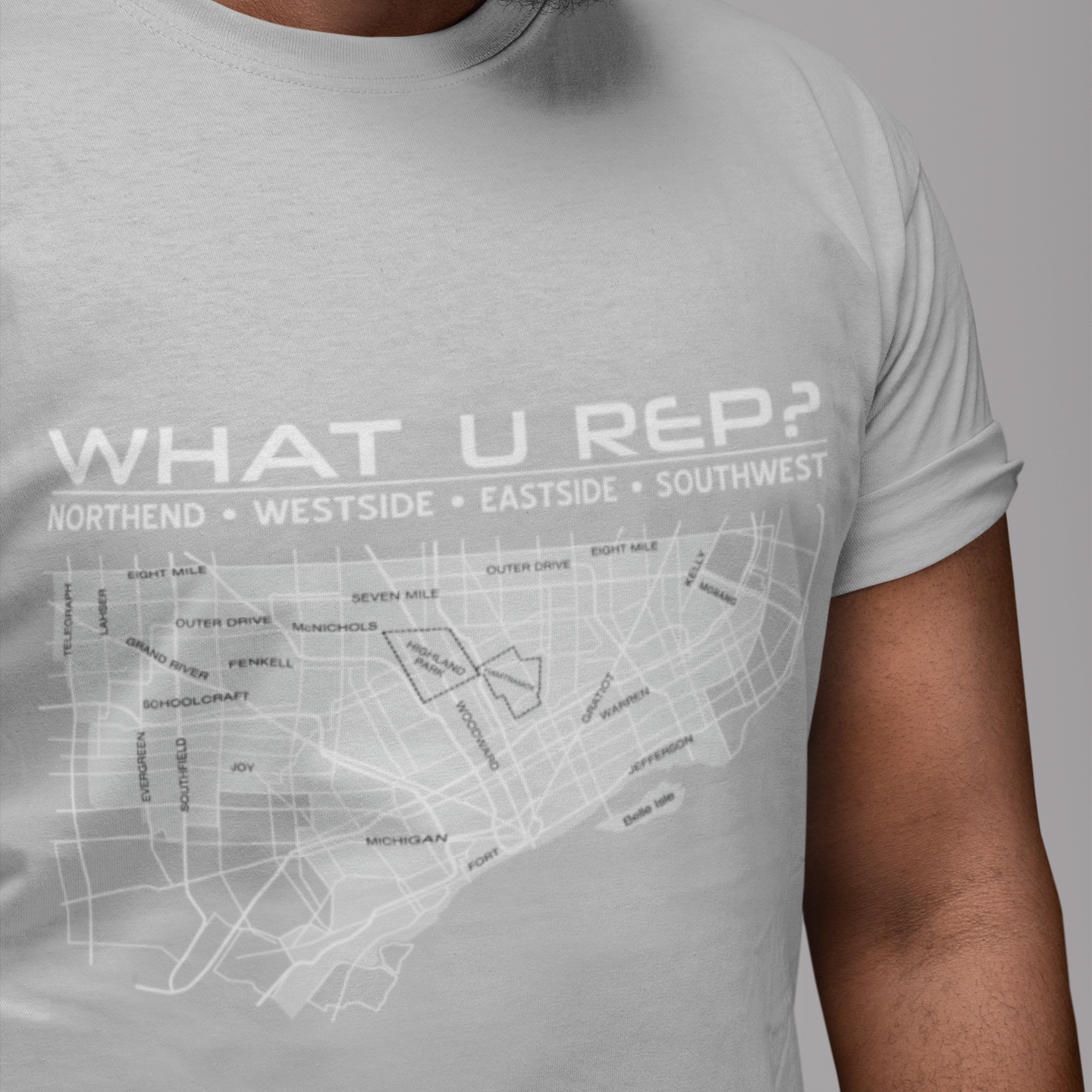 Man wearing a gray t-shirt with 'WHAT U REP?' design on a gray background